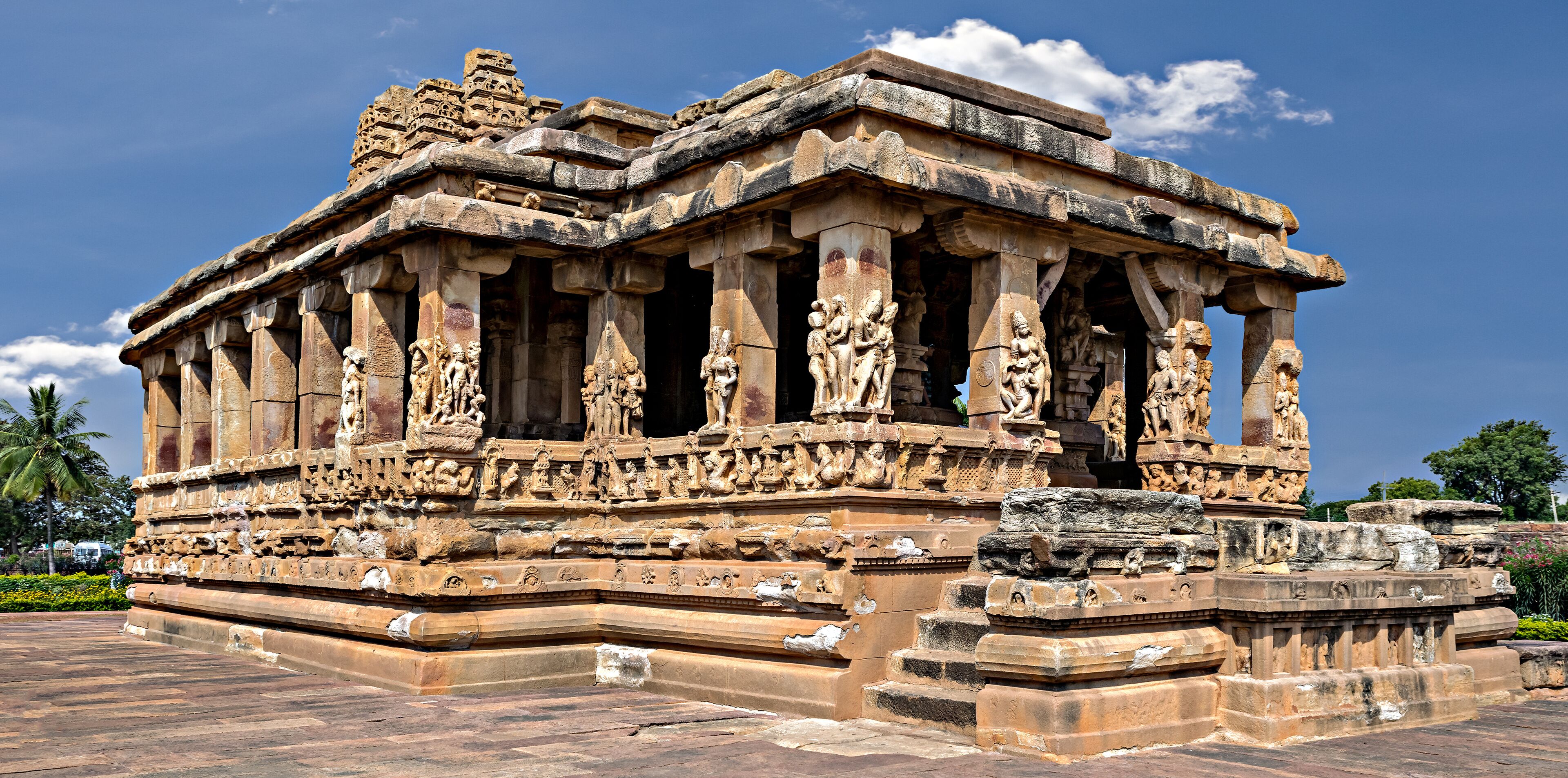 A detailed stone temple with intricate carvings and a clear blue sky.