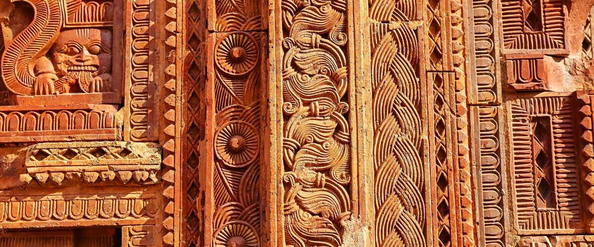 Intricate carvings and patterns on a structure, likely a temple or historical monument.