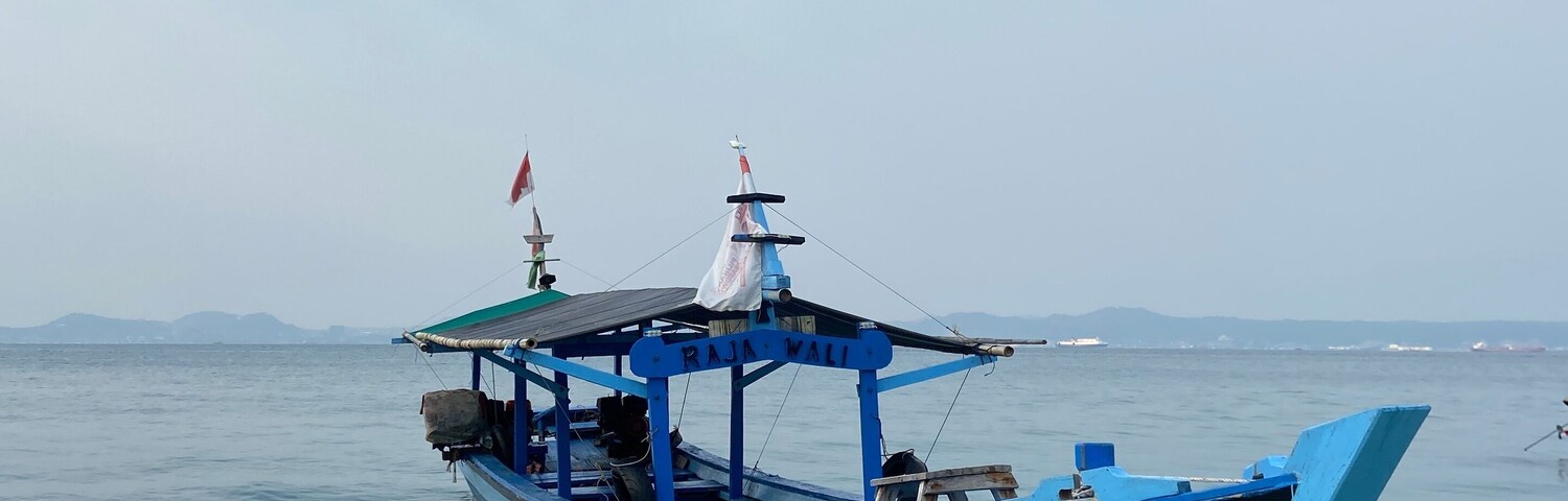 Bandar Lampung, Indonesia - September 1st 2024: Fishing boats are parked on the seashore in the afternoon with a cloudy sky in the background