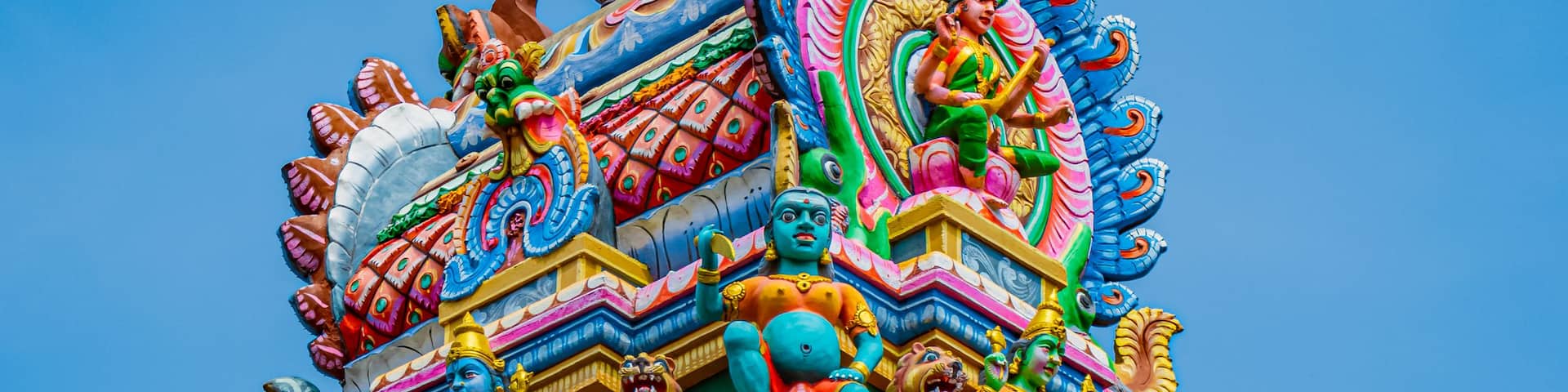 A multi-tiered temple with vibrant, colorful decorations and intricate carvings.