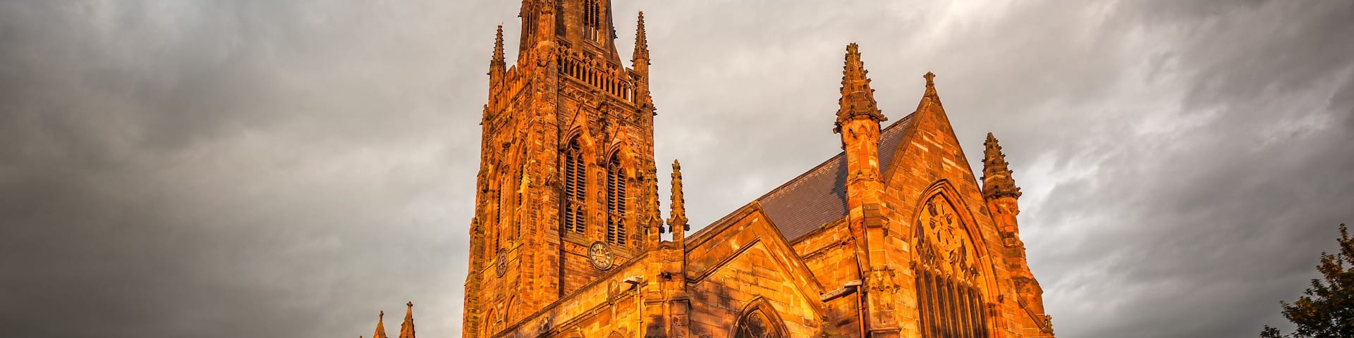 A Gothic-style church with a tall spire and intricate stonework.