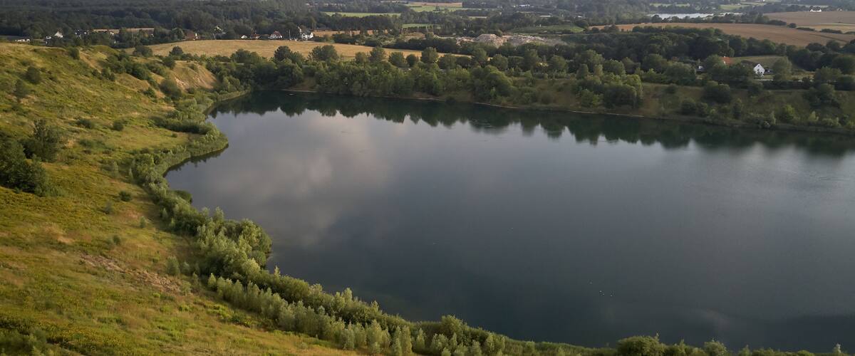 A lake surrounded by hills and trees.