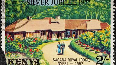 Kenya - circa 1977: A Kenyan postage stamp depicts Elizabeth II and Prince Philip at Sagana Lodge. Circa 1977.