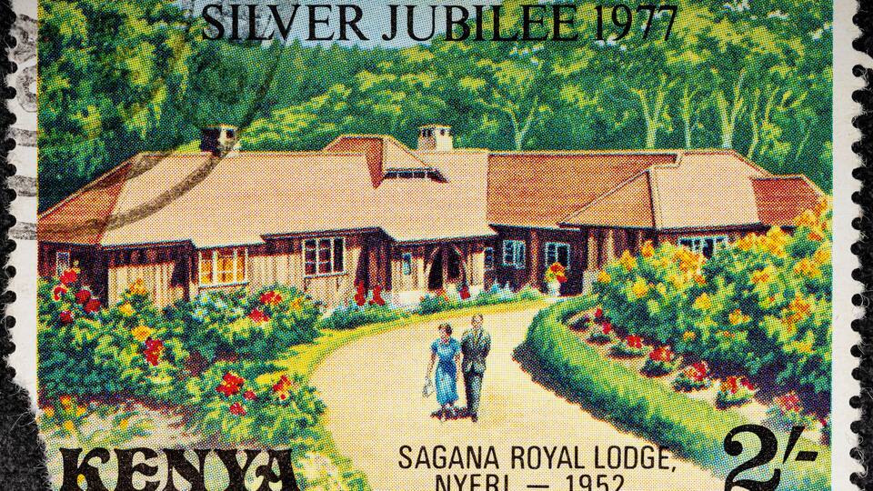 Kenya - circa 1977: A Kenyan postage stamp depicts Elizabeth II and Prince Philip at Sagana Lodge. Circa 1977.