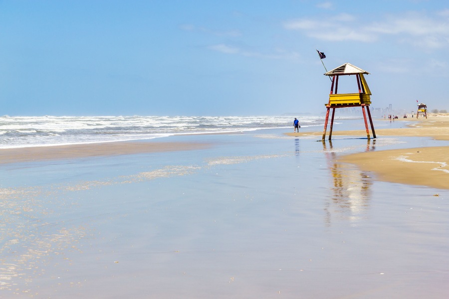 Sunny day with waves and blue sky at Balneario da Gaivota, Santa catarina. Torres in backgorund.; Shutterstock ID 523872748; Purchase Order: -