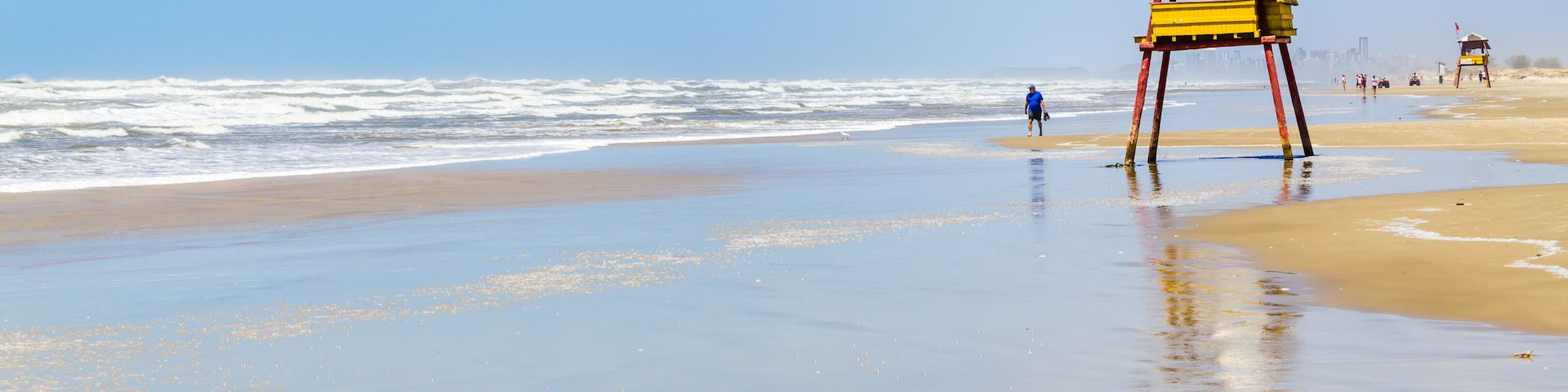 Sunny day with waves and blue sky at Balneario da Gaivota, Santa catarina. Torres in backgorund.; Shutterstock ID 523872748; Purchase Order: -