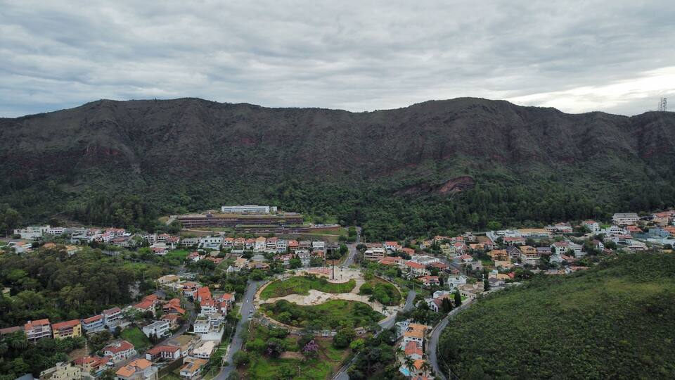 A town nestled in a valley surrounded by mountains, with a central plaza and residential buildings.