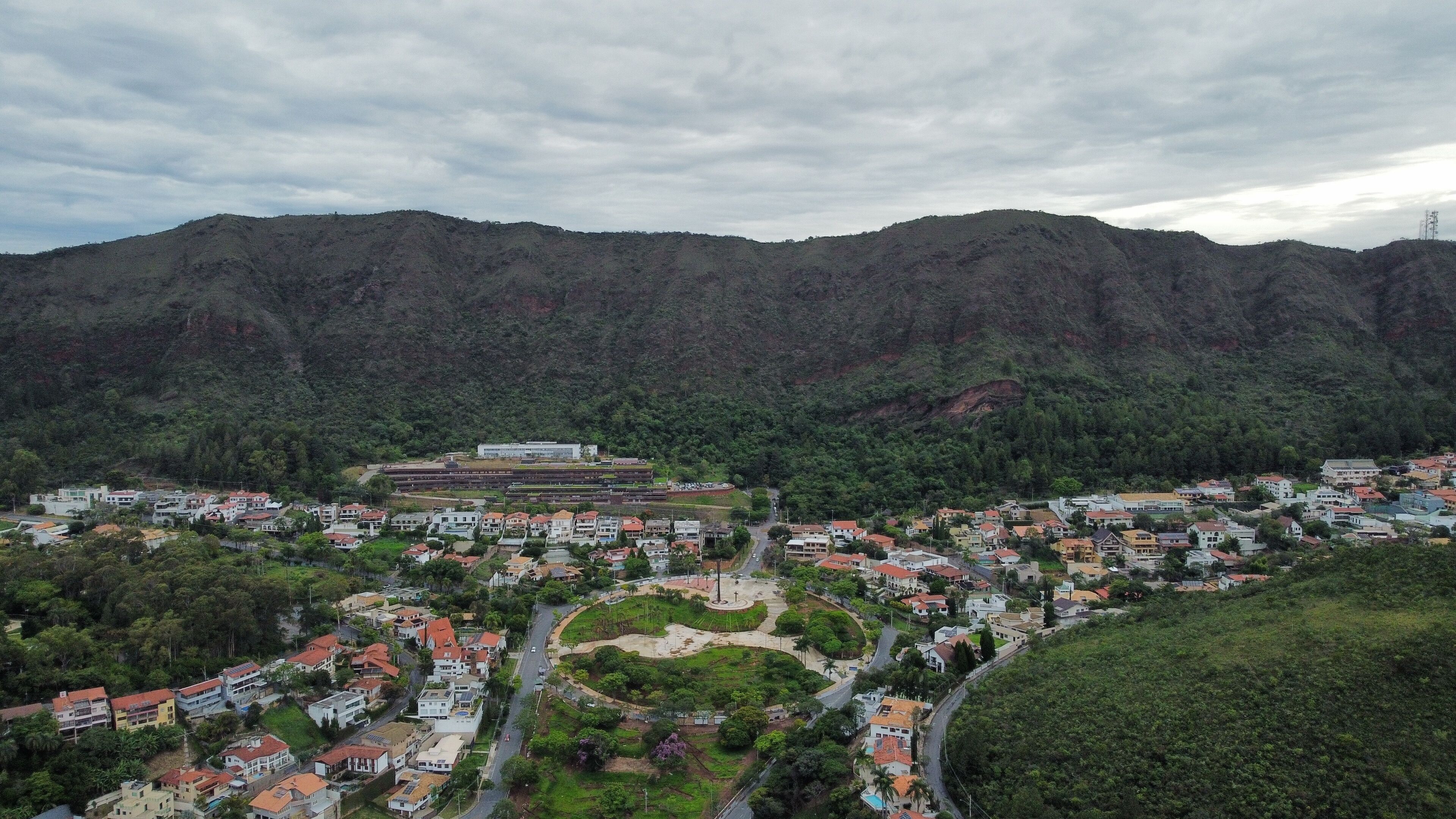 A town nestled in a valley surrounded by mountains, with a central plaza and residential buildings.