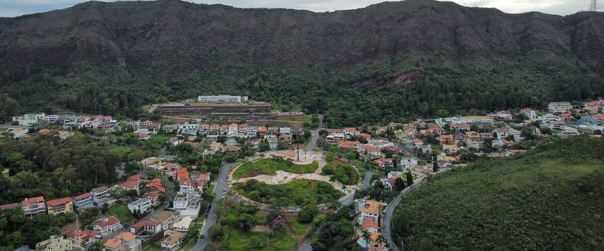 A town nestled in a valley surrounded by mountains, with a central plaza and residential buildings.