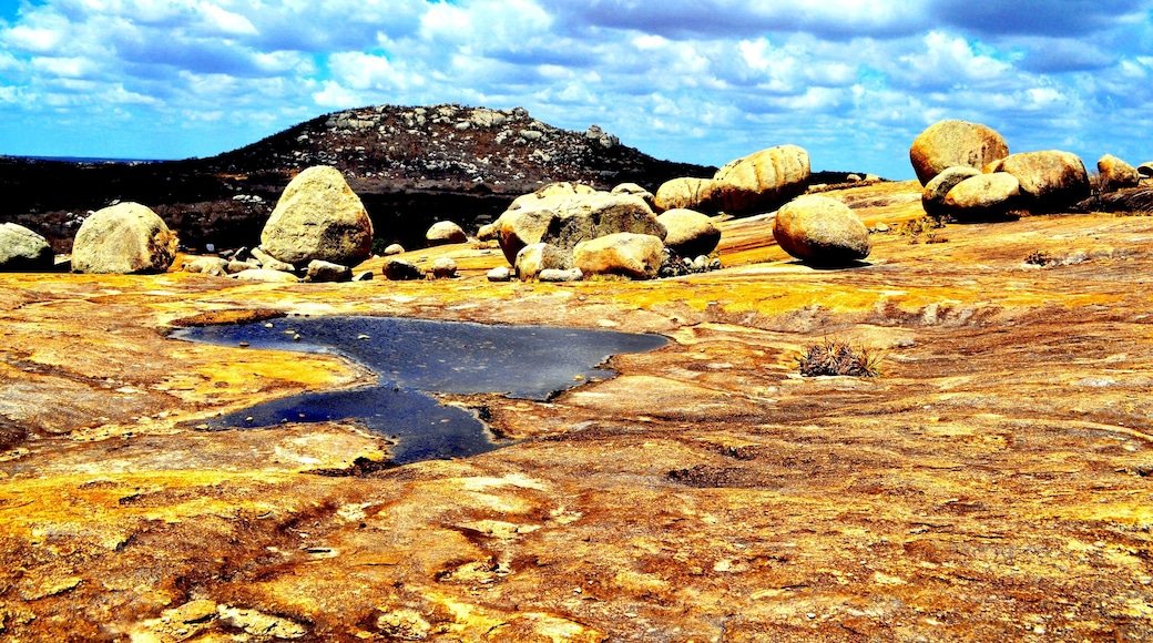 Lajedo do Pai Matheus is a mystic and secluded area in the Northeast high desert. From the top plateau you can see the lasgest monolites sculped by nature and the small lakes formed by erratic rainfalls, which also paint the soil and the rocks with amazing yellow, brown and vivid orange, due the action of minerals and oxidation.