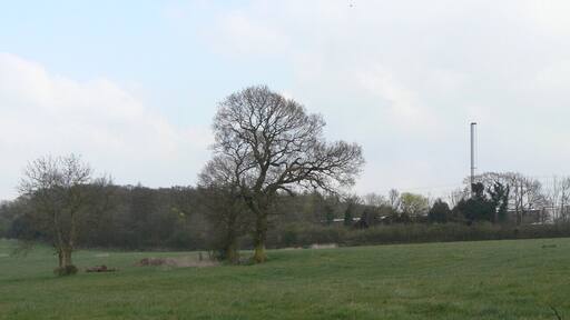 Fields near Codnor Gate Visible to the right is the chimney of the local flooring materials factory. The woodland in the background has grown up on the spoil heap of the former Butterley Park No.5 colliery.