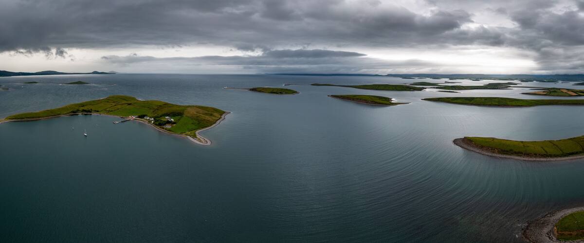 A coastal landscape with multiple small islands surrounded by water.