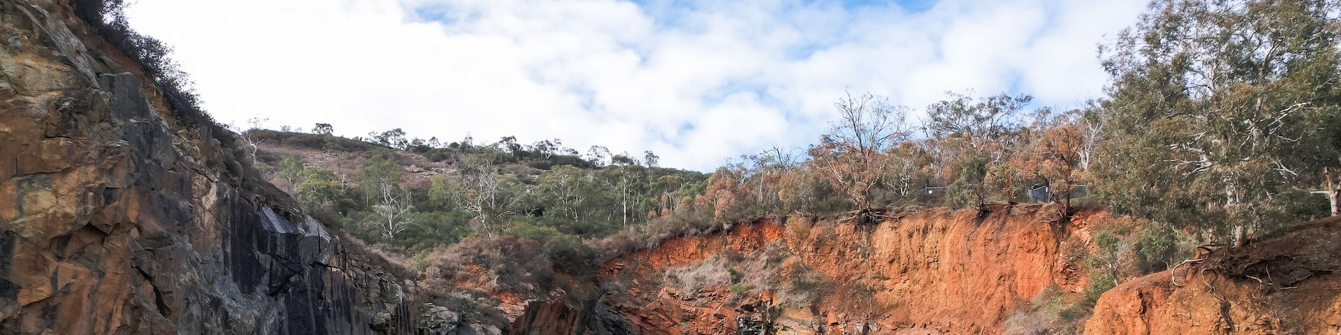 Family looking at the old abandoned Barrington Quarry in Ellis Brook Valley Reserve, Perth