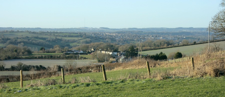 South west from Tunley Hill A fence blocks our path, Meadgate is at the bottom of the hill and Paulton is further over. The high point on the horizon to the left is Pen Hill with its TV transmitter ST5648