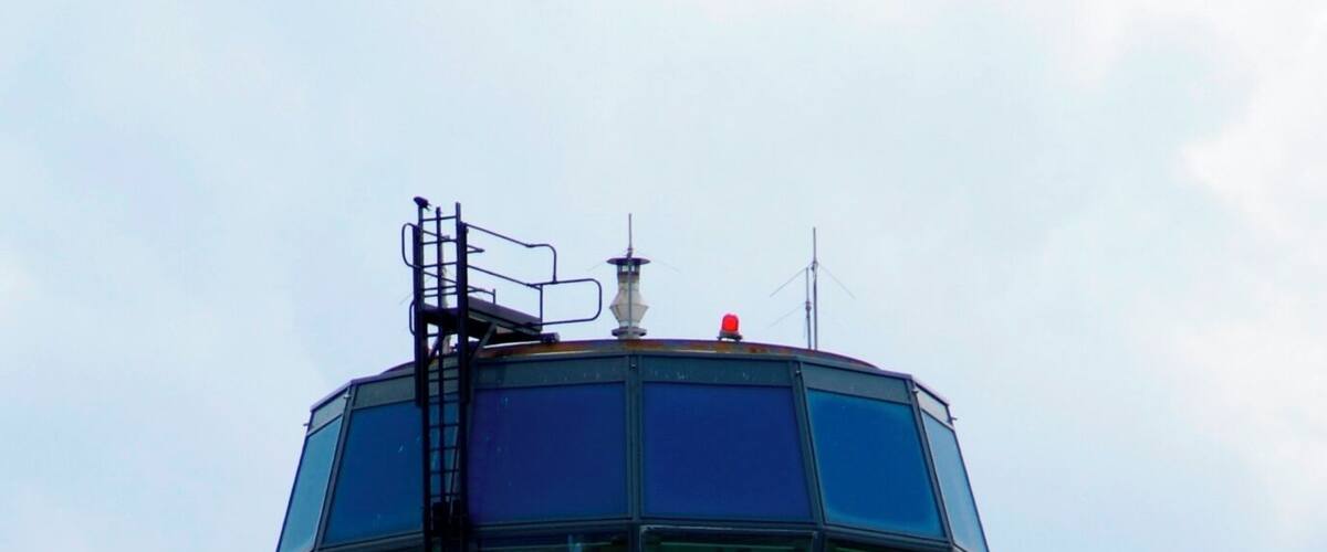 A control tower with a hexagonal observation room and a white base.