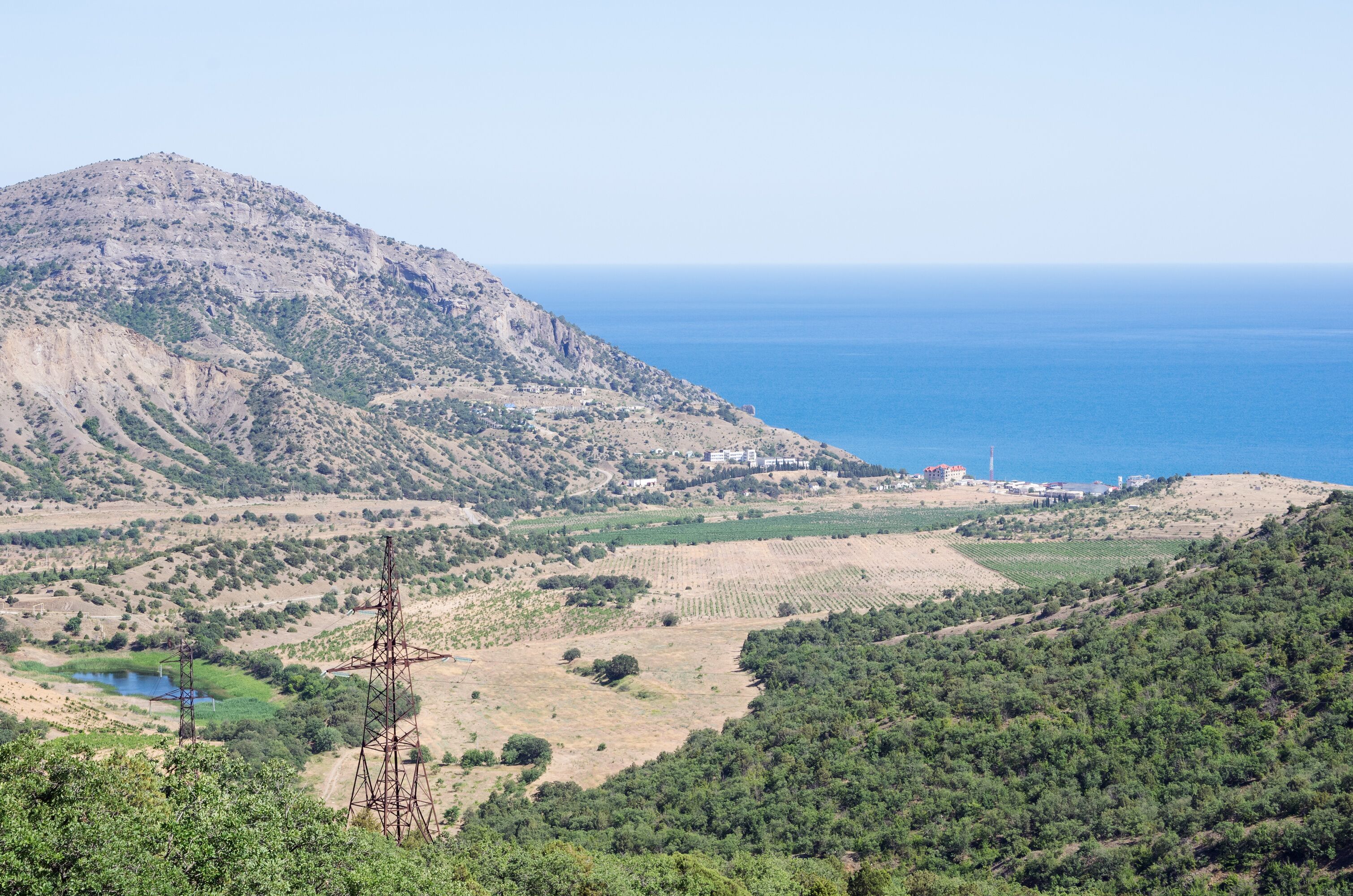Russia, the Republic of Crimea, Sudak city district, Vesyoloe village. 06/08/2018: View of the village on the shore of the Black Sea