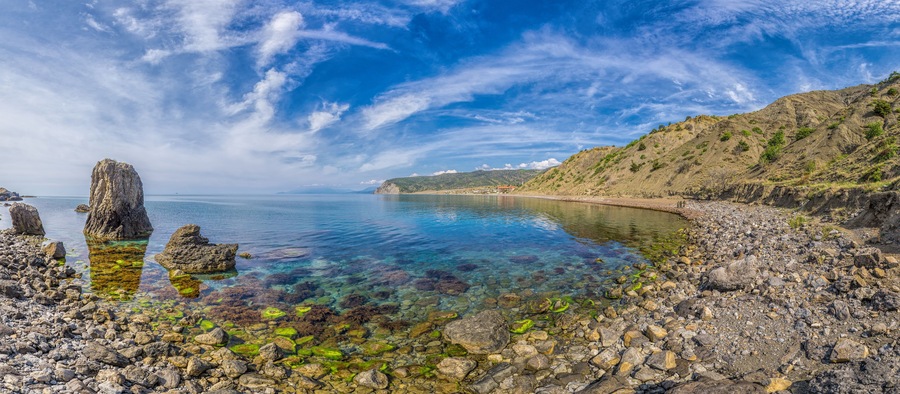 Panoramic View of Cape Ai-Fock, Veselovskaya bay and the beach of the village of Vesyoloe in the Crimea. On the foreground is the western foot of Mount Karaul-Oba. Azure Black Sea near Sudak