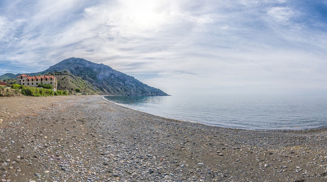Panoramic View of Cape Ai-Fock, Veselovskaya bay and the beach of the village of Vesyoloe in the Crimea. On the foreground is the western foot of Mount Karaul-Oba. Azure Black Sea near Sudak