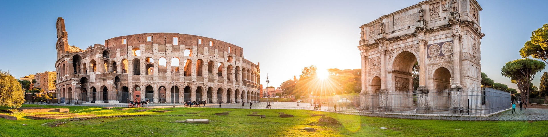Panoramic view of Colosseum and Constantine arch at sunrise. Rome, Italy
