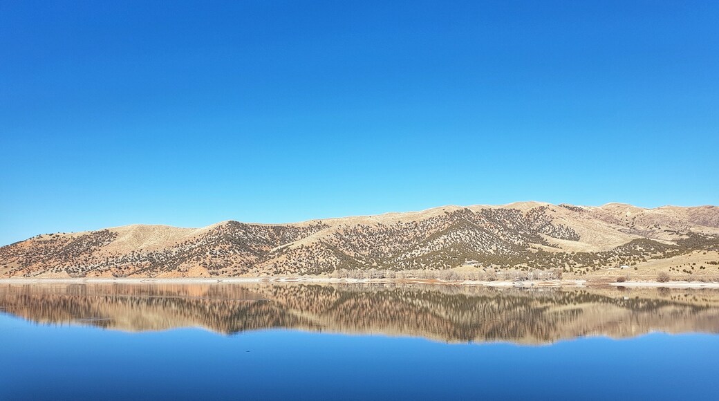 beautiful landscape of hills reflection at Echo Reservoir with stunning beautiful clear sky as background in Utah, USA