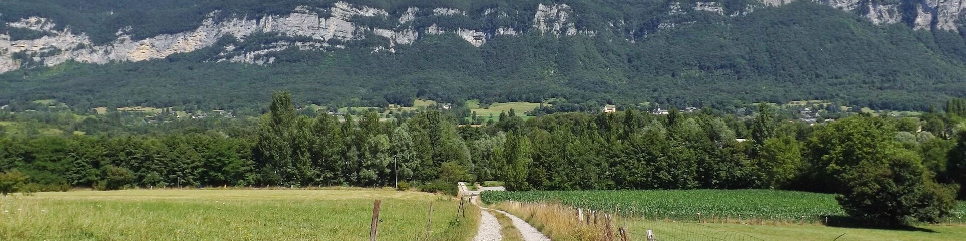 Sight of the Chemin de Lachat rural track, with the Bauges mountain range at the background, in Drumettaz-Clarafond in Savoie, France.