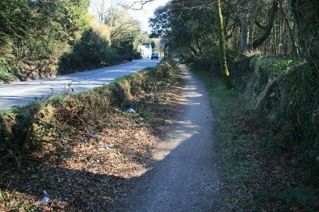 Line of old tramway near Scorrier Although it looks like a sunken pathway lying beside the B3298, this is the former trackbed of the Portreath Tramway, which now forms a section of the mineral tramways trail that links up with the line of the old Redruth and Chasewater Railway.