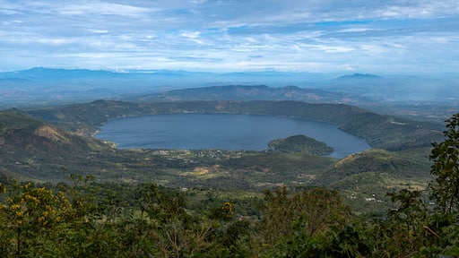 Wide angle panoramic aerial view of Lake Coatepeque with Teopan Island - inactive volcano crater lagoon in western mountain region of El Salvador near Santa Ana city.