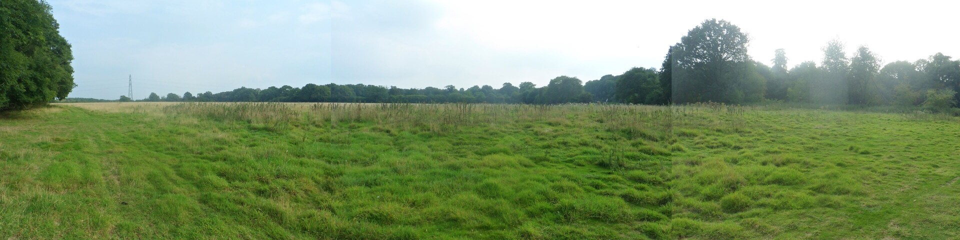 One of a series of photos chronicling the development of Crawley New Town's 14th residential neighbourhood, Forge Wood. This three-photo panorama shows a large field on the south side of the public footpath leading from Balcombe Road (opposite the Steers Lane junction) past Toovies Farm, across the M23 and eventually to Copthorne. This land will be developed with housing as part of Phase 2 of the Forge Wood neighbourhood.