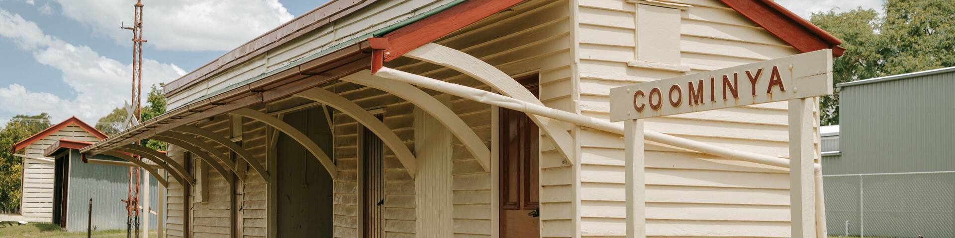 Coominya which includes a small town or village and signage