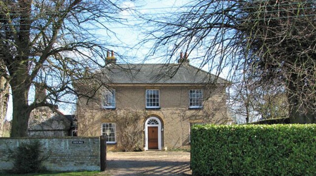 Colts Hall. At the east end of the village green. The village of Shouldham > 1738593 is situated about 10 kilometres north-east of Downham Market (South West Norfolk) and has a population of approximately 500. Immediately to the east and north-east of the village, on the south side of the Nar valley bottom which used to be a fen in medieval times, lies the site of the Priory of the Holy Cross and the Blessed Virgin. This site is a designated National Monument and contains the buried remains of monastic buildings, earthwork enclosures and remains of an extensive water management system including fishponds > https://www.geograph.org.uk/photo/1738428. The site can be accessed via the public footpath turning off Eastgate Street > https://www.geograph.org.uk/photo/1738587 and leading to Marham, further to the east, which traverses it. Found within the same area there are also remains of a section of road which is believed to date from Roman times, and a Bronze Age cremation cemetery. For more information see: http://www.magic.gov.uk/rsm/21335.pdf. The church of All Saints > https://www.geograph.org.uk/photo/1738436 stands on an elevation above the site, looking down onto the village.
