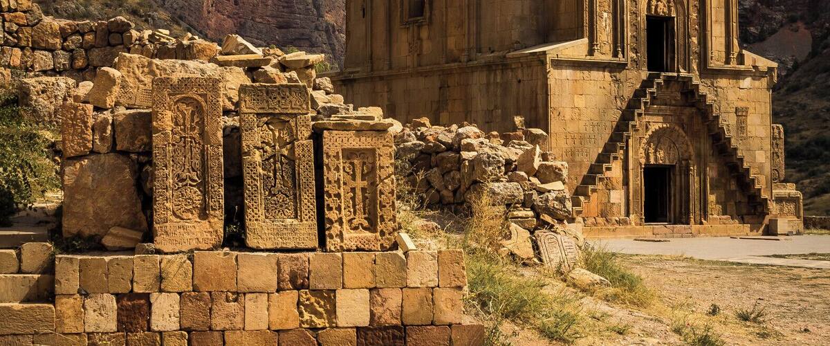 Beautiful old monestary in Armenia set amongst a set of mountains.