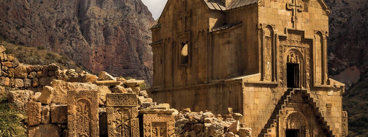 Beautiful old monestary in Armenia set amongst a set of mountains.