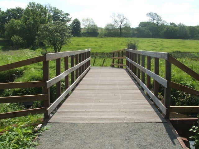 Footbridge crossing the Bonny Water In Bonnyfield Nature Park.