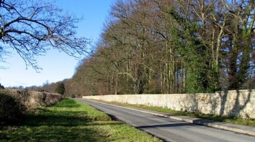 Oakham Road westwards The boundary wall of Exton Hall park is to the right.