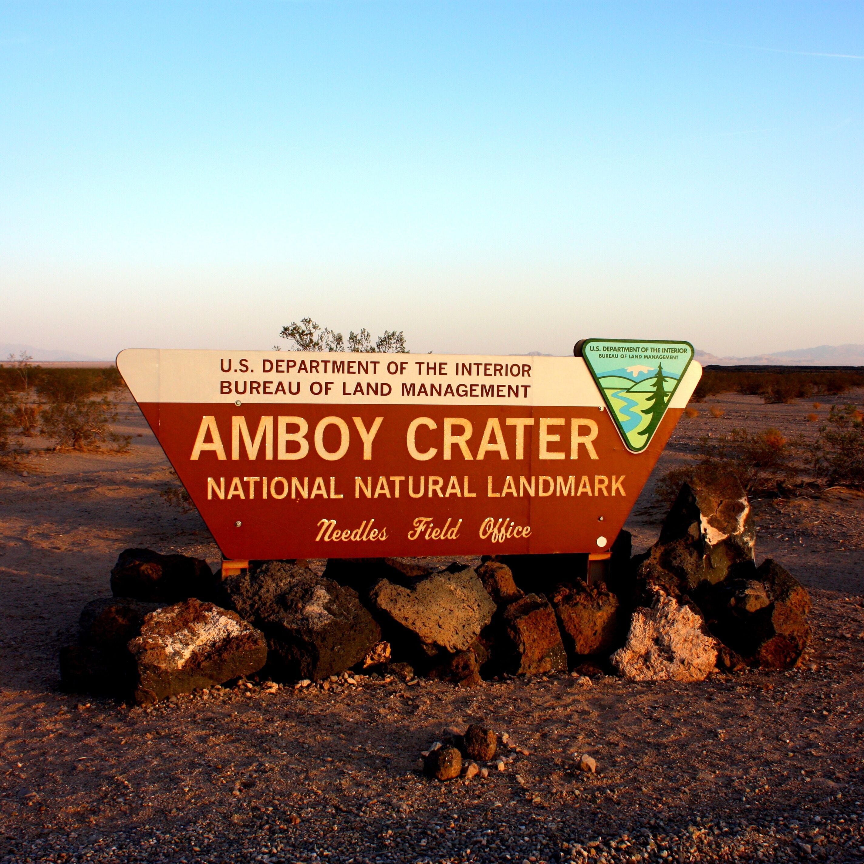 A sign for Amboy Crater National Natural Landmark with the U.S. Department of the Interior Bureau of Land Management logo.
