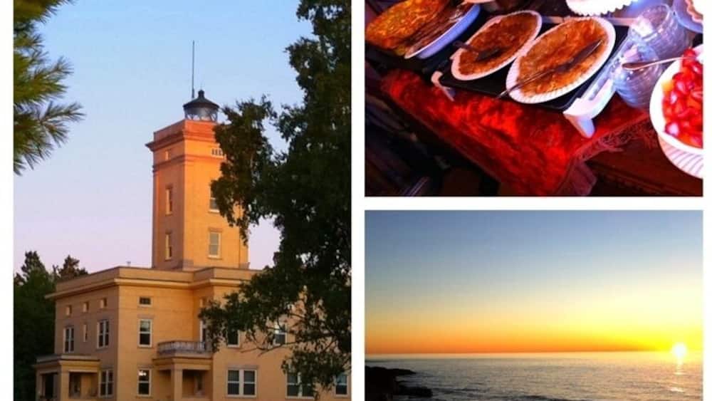 A coastal building, a table with food, and a sunset over the ocean.