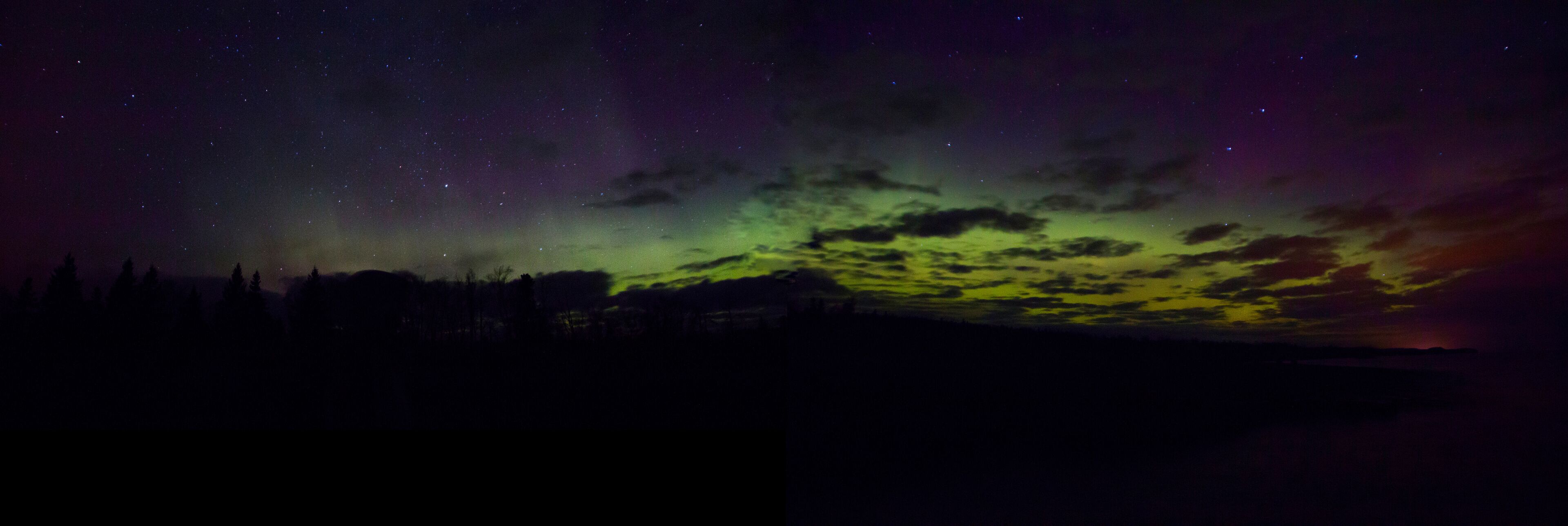 A night sky with stars and the aurora borealis.