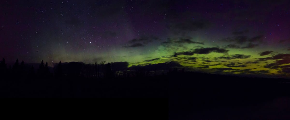 A night sky with stars and the aurora borealis.