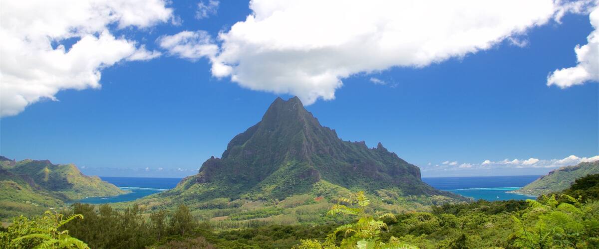 A mountain with a clear sky and clouds.