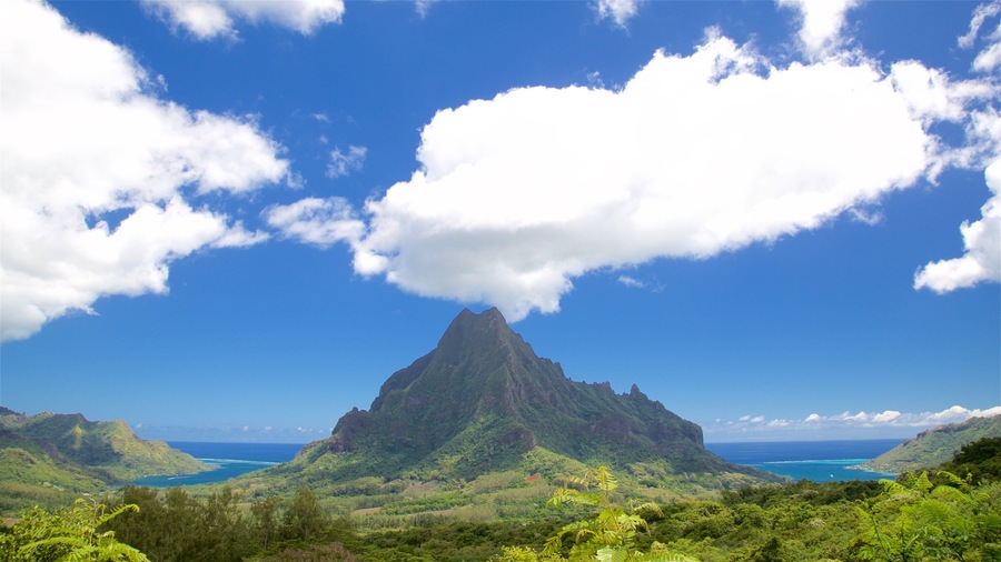 A mountain with a clear sky and clouds.