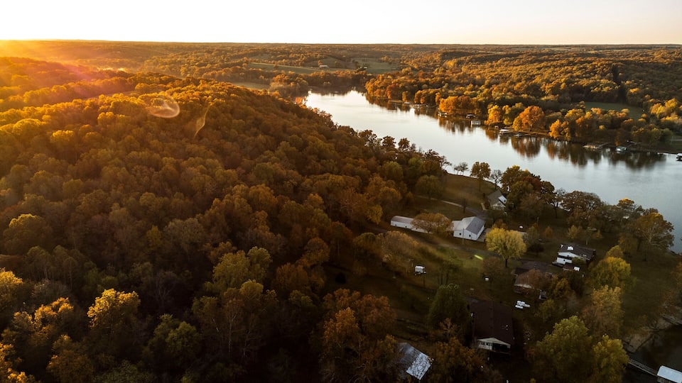 A river winding through a forested valley with autumn foliage.