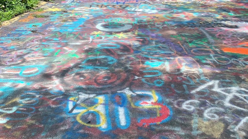 A pathway covered with colorful graffiti.