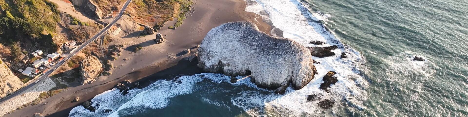 Large rocks natural monument Piedra de Iglecias Church stone on Chilean coast in Constitucion in sunset.