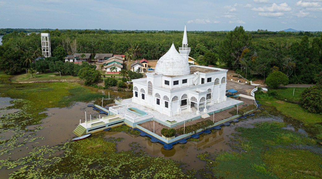 Drone shot of a white mosque from high angle view at Danau Tok Uban, Tanah Merah, Kelantan, Malaysia.