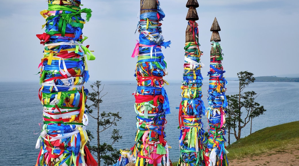 #Adventure Contest
Sacred shaman poles on Olkhon Island, called the heart of Lake Baikal.
The Shaman Rock is one of the nine most holy places in Asia. 13 totem poles stand tall at the entrance, guarding the sacred rock, representing the 13 deities of Olkhon and bearing colorful ribbons, known as ‘Khadag’, placed by pilgrims. The five colors symbolize different aspects of the environment. Blue for the eternal sky, green for the earth, yellow for religion, red for fire, white for milk.