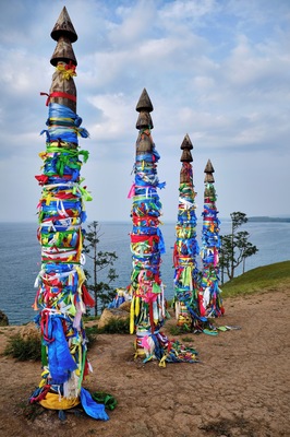 #Adventure Contest
Sacred shaman poles on Olkhon Island, called the heart of Lake Baikal.
The Shaman Rock is one of the nine most holy places in Asia. 13 totem poles stand tall at the entrance, guarding the sacred rock, representing the 13 deities of Olkhon and bearing colorful ribbons, known as ‘Khadag’, placed by pilgrims. The five colors symbolize different aspects of the environment. Blue for the eternal sky, green for the earth, yellow for religion, red for fire, white for milk.