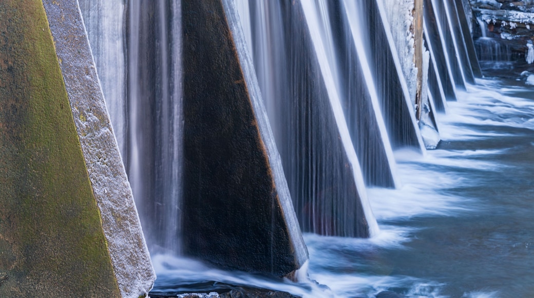 A series of cascading waterfalls with a rocky foreground.