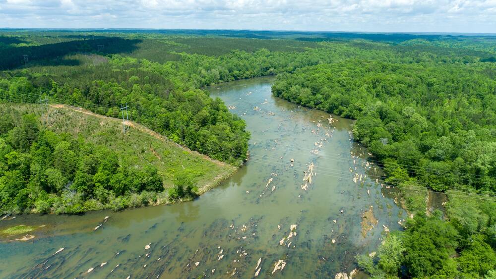 Aerial View of Rocky Riverbed and Lush Forest Irwin Shoals on Lake Martin, Alabama