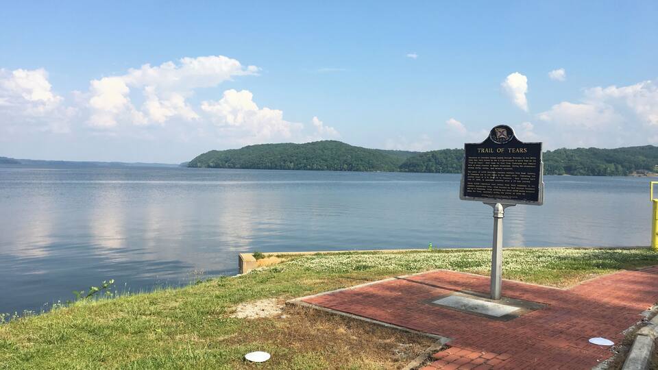 A lake with a signboard titled 'Trail of Tears'.