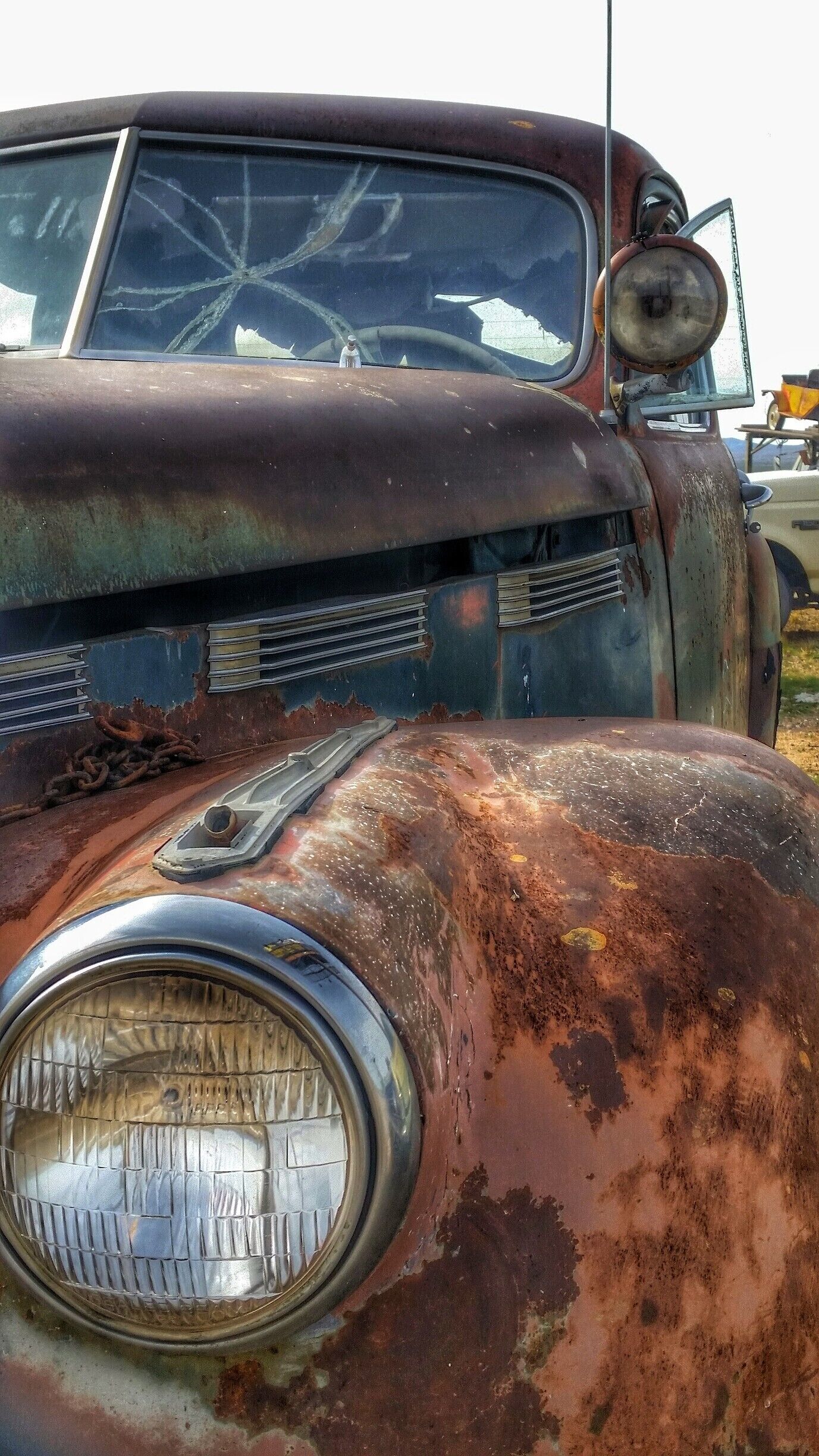 A rusty, abandoned vehicle with visible rust and damage.